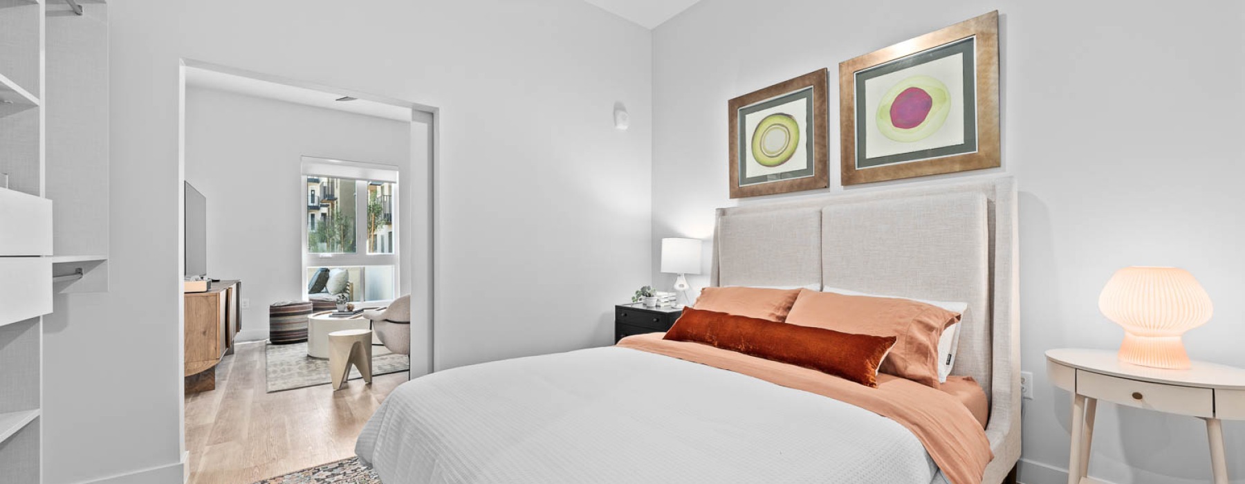 Primary Bedroom with bedframe, large window light fixture