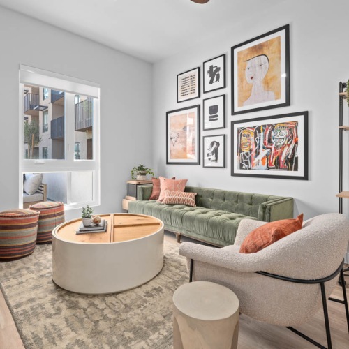 Model living room at The Monde apartments for rent in Scottsdale, AZ, featuring wood grain floor paneling.